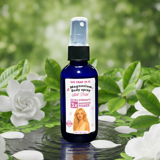 bottle of silk petal magnesium spray surrounded by white gardenia florals